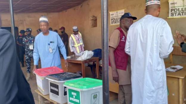 President Buhari is pleased as voters line up in the heat.