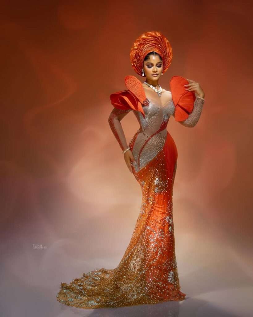 Shine Rosman Glows Like Golden Hour in Fiery Orange & Sculptural Gele